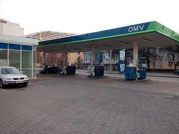 A well-lit OMV petrol station with a cozy bakery and coffee shop