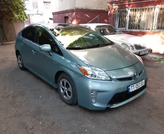 Hybrid 1.8L engine of Toyota Prius 2013 for rental at Tbilisi Airport.