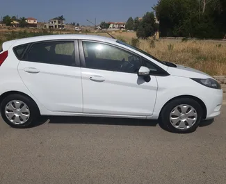 Ford Fiesta 2015 car hire in Cyprus, featuring ✓ Petrol fuel and 98 horsepower ➤ Starting from 26 EUR per day.