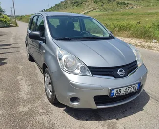 Front view of a rental Nissan Note in Tirana, Albania ✓ Car #6983. ✓ Manual TM ✓ 2 reviews.