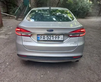 Hybrid 2.0L engine of Ford Fusion Sedan 2017 for rental at Tbilisi Airport.