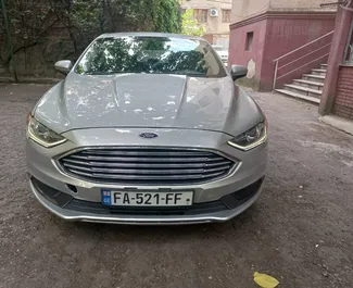 Front view of a rental Ford Fusion Sedan at Tbilisi Airport, Georgia ✓ Car #7129. ✓ Automatic TM ✓ 0 reviews.